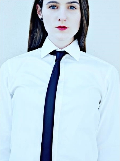 White button up, black skinny tie. Straight on portrait. Red lips blue eyes brown hair. Exposure up to a 1000. Blank staaare. I swear I can smile.